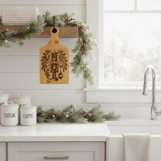 The Nutcracker cutting board hanging as festive decor in a modern farmhouse kitchen.