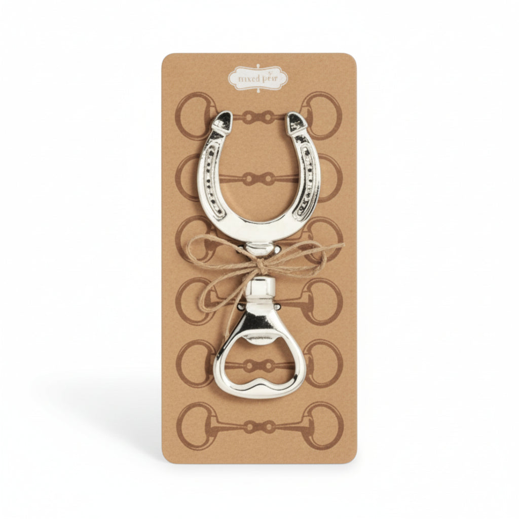 Silver bottle opener shaped like a horseshoe on a cardboard backing.