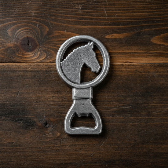The cast iron Horse Bottle Opener shown on a wooden bar top.