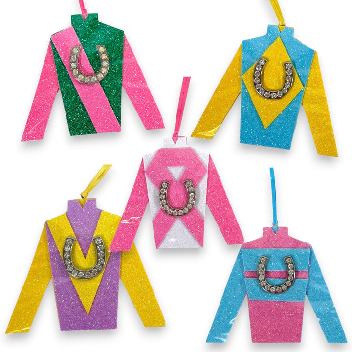 Colorful jockey silks with glitter and horseshoe ornaments on a white background