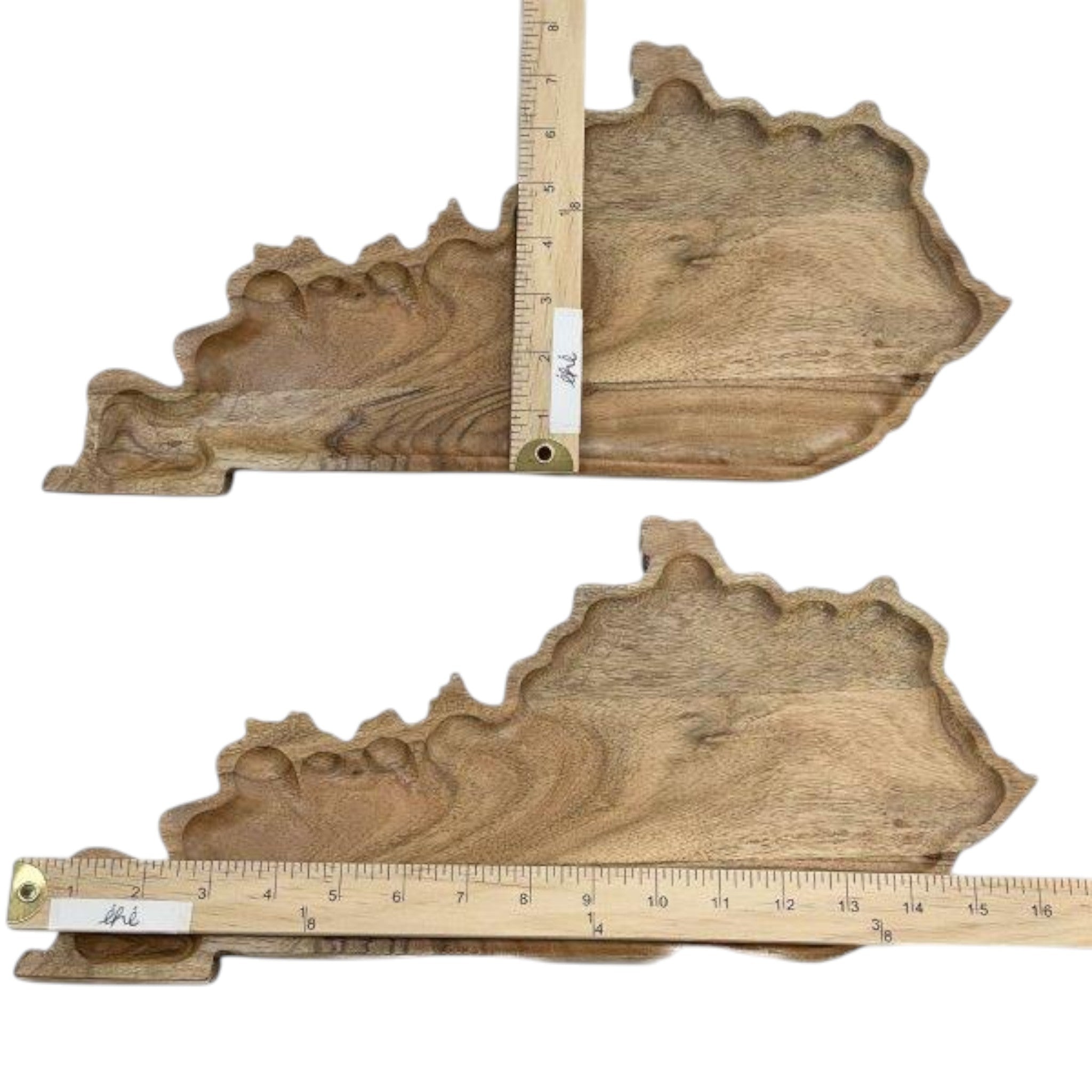 Two wooden decorative pieces shaped like states with rulers for scale on a white background