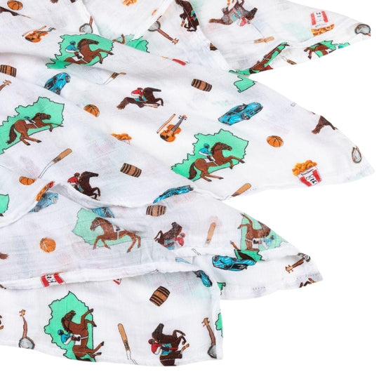 Fabric with cowboy-themed pattern featuring horses, boots, and hats on a white background