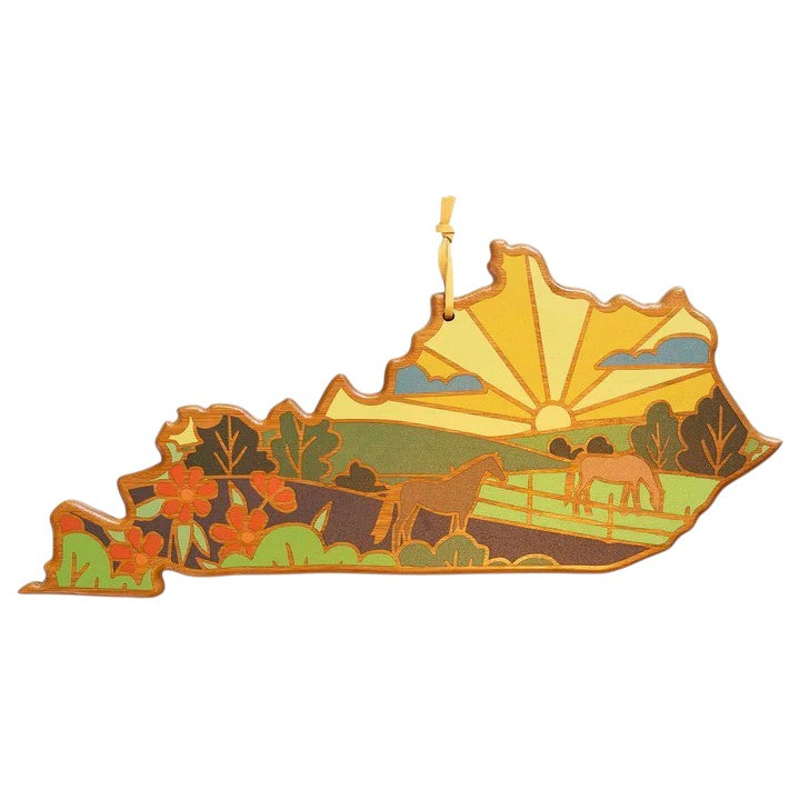 Decorative ornament shaped like a stylized map with horses and nature elements on a white background