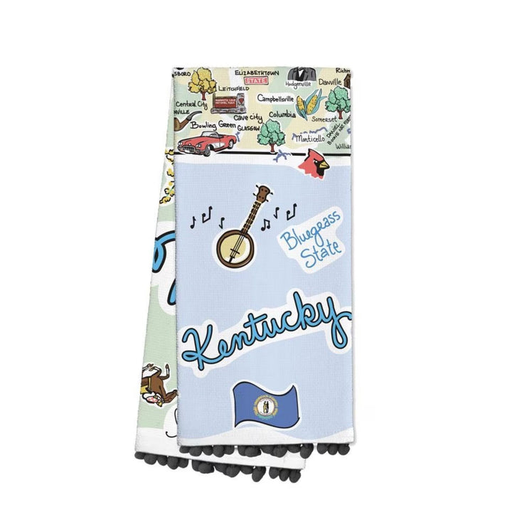 Close-up of the Kentucky tea towel showing a classic banjo illustration, "Bluegrass State" text, and a playful dark grey pom-pom trim along the bottom edge.