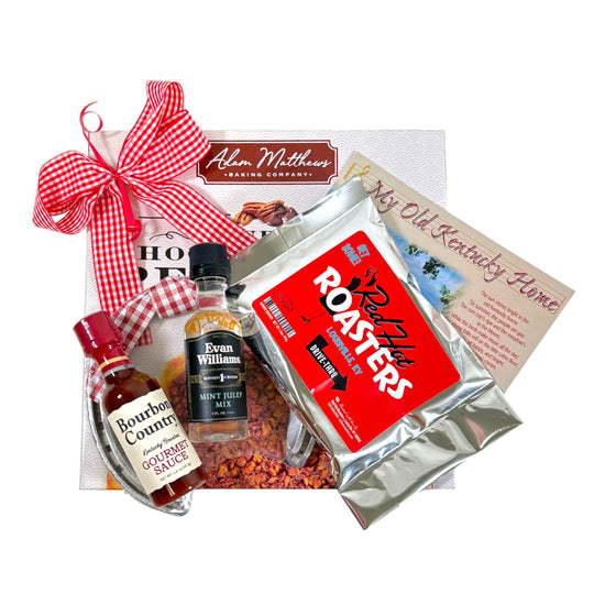 The Kentucky Bourbon Pecan Pie Gift Set displayed with a chocolate chip pecan pie, coffee, and bourbon sauces.