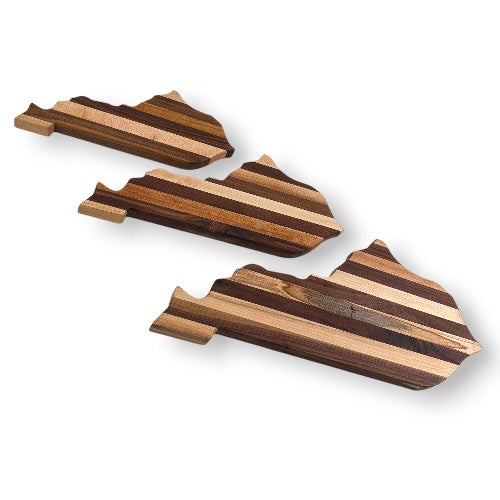 Three wooden cutting boards with striped pattern on a white background