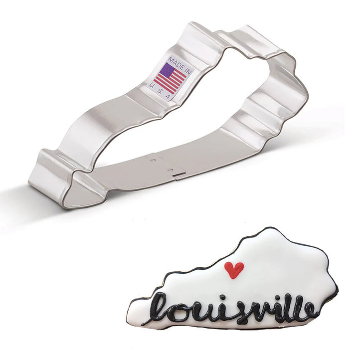 Cookie cutter shaped like the state of Kentucky with 'Louisville' and a heart, next to a cookie with the same design.
