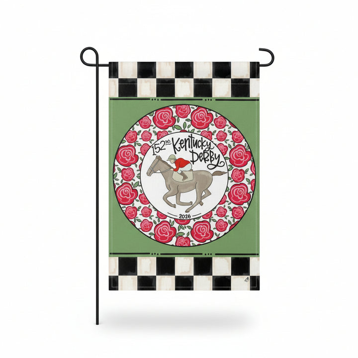 The 152nd Kentucky Derby Ring of Roses garden flag displayed on a stand, showing the checkered border and central horse and jockey emblem.