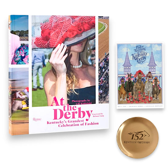 Flat lay of Kentucky Derby 152 collector gift set with fashion book, bronze coaster, and official Derby art postcard