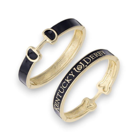 Close-up view of the black enamel snaffle bit bangle, showing the detailed gold snaffle bit design.