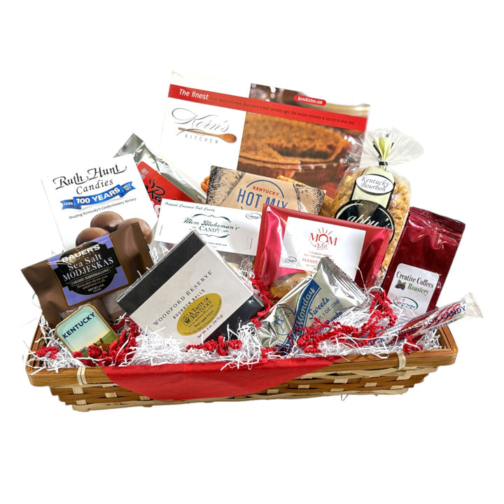 The Kentucky Dessert Tray gift basket displayed in a wicker tray, overflowing with local sweets, chocolates, and snacks.