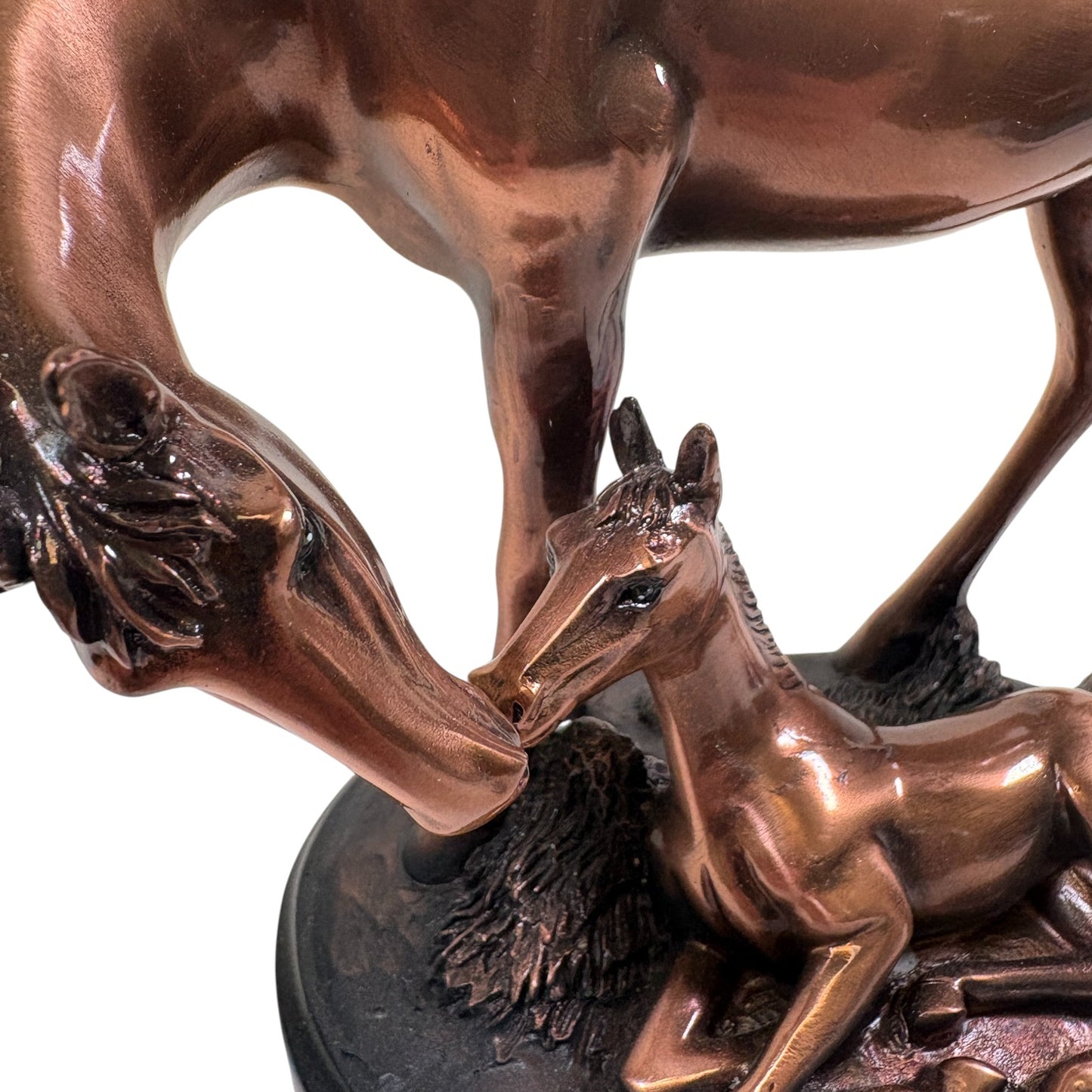 A close-up showing the rich copper texture and heartwarming design of the mother and foal sculpture.