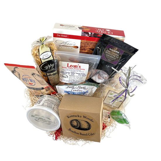 An overhead flatlay showing all the items in the Barrel of Goodness gift basket, including a Derby Pie, Bourbon Barrel Cake, and various candies.