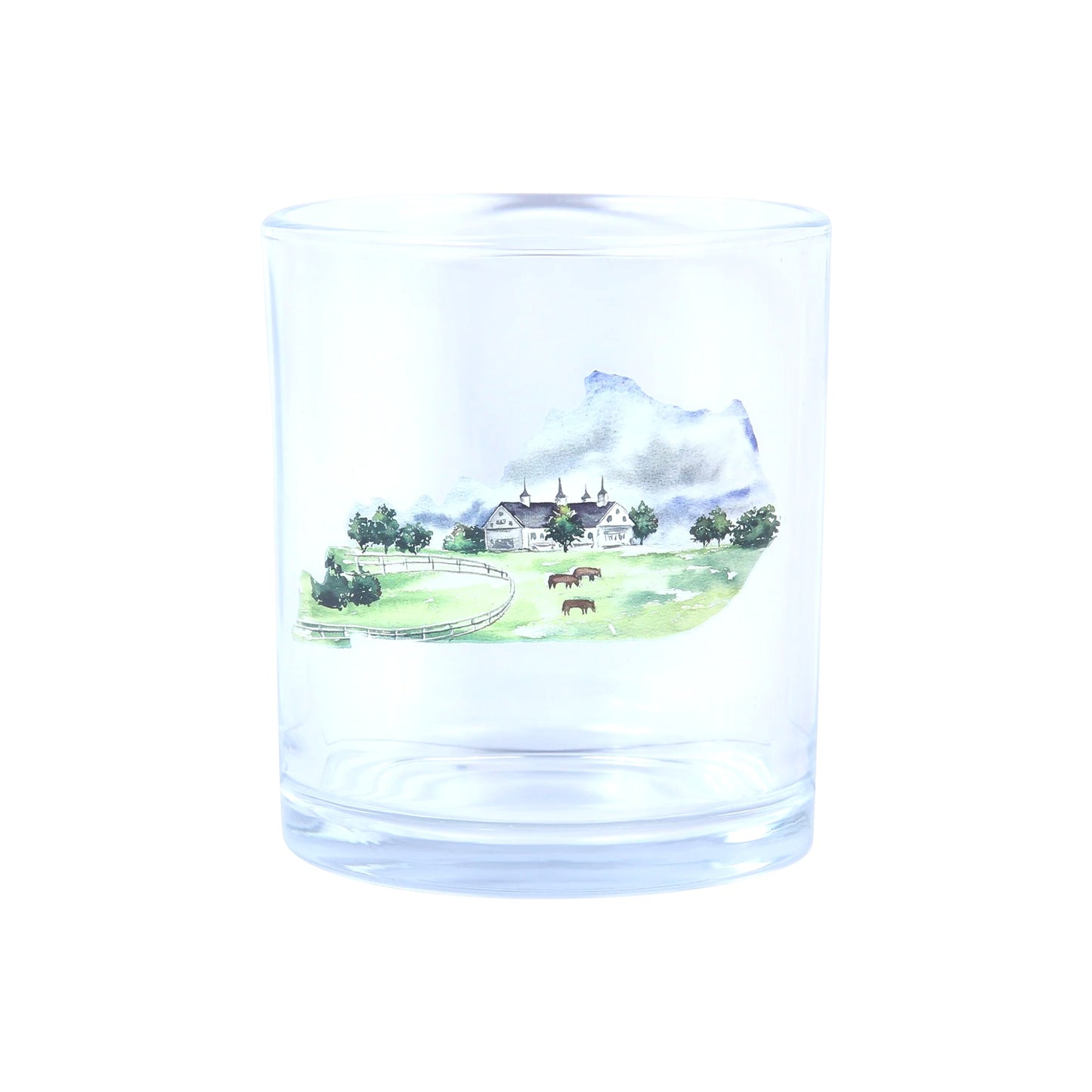 Clear glass tumbler with a scenic engraving of a house and landscape.