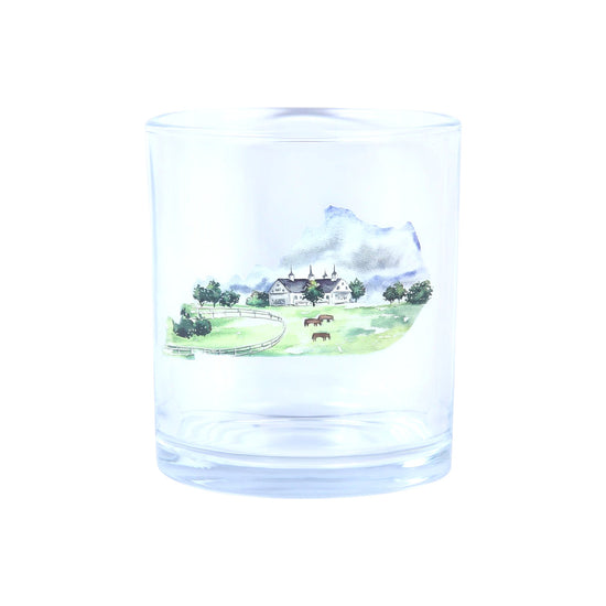 Clear glass tumbler with a scenic engraving of a house and landscape.