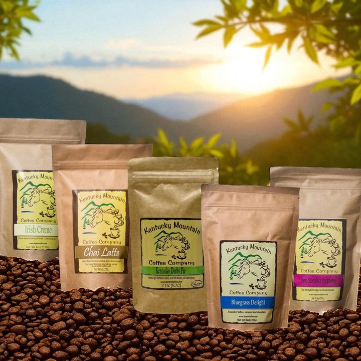 Coffee bags from Kentucky Mountain Coffee Company on a bed of coffee beans with a scenic background.