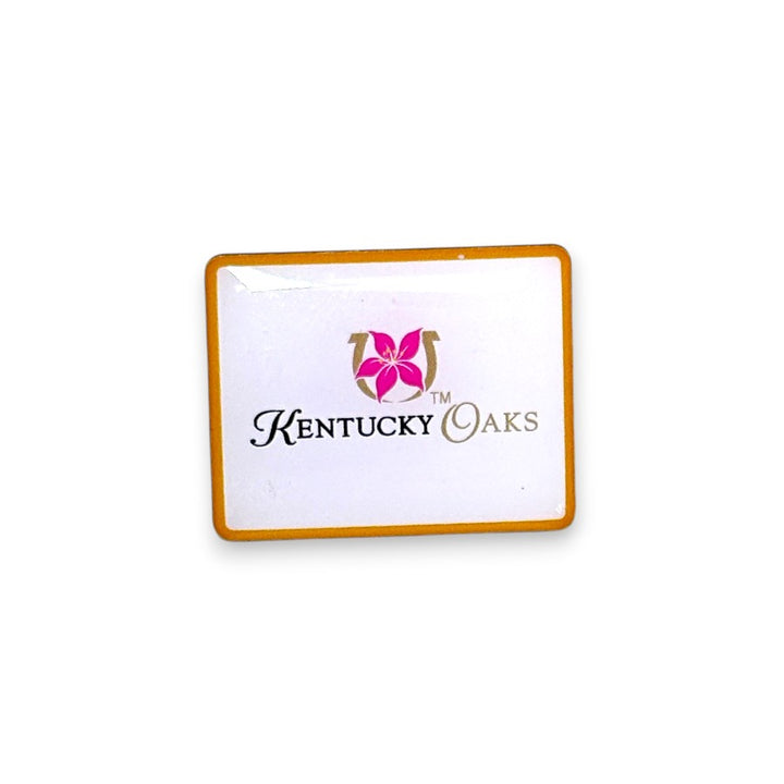 The official Kentucky Oaks rectangular enamel pin with a gold border, showing the pink lily and horseshoe logo above "Kentucky Oaks" cursive text on a white background.
