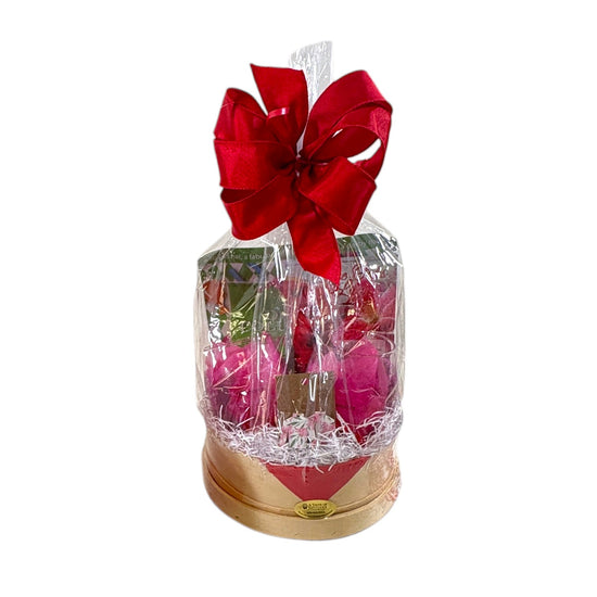 A vibrant pink and lime green Kentucky Oaks gift basket in a round wooden base featuring cocktail mix, commemorative glasses, and lily earrings.