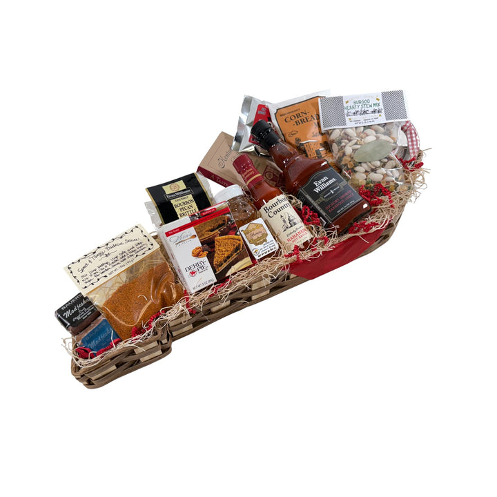 Gourmet gift basket in the shape of Kentucky with various items including chocolate, Derby pie, Evan Williams barbeque sauce, and hot sauce on a white background