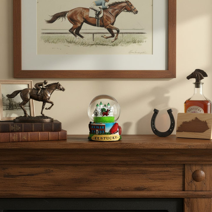 The Kentucky Snow Globe displayed on a rustic wooden mantelpiece next to other decor.