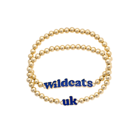 Gold beaded bracelet with 'Wildcats uk' charm on a white background