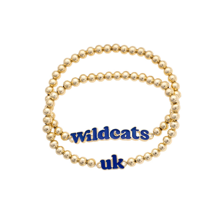 Gold beaded bracelet with 'Wildcats uk' charm on a white background