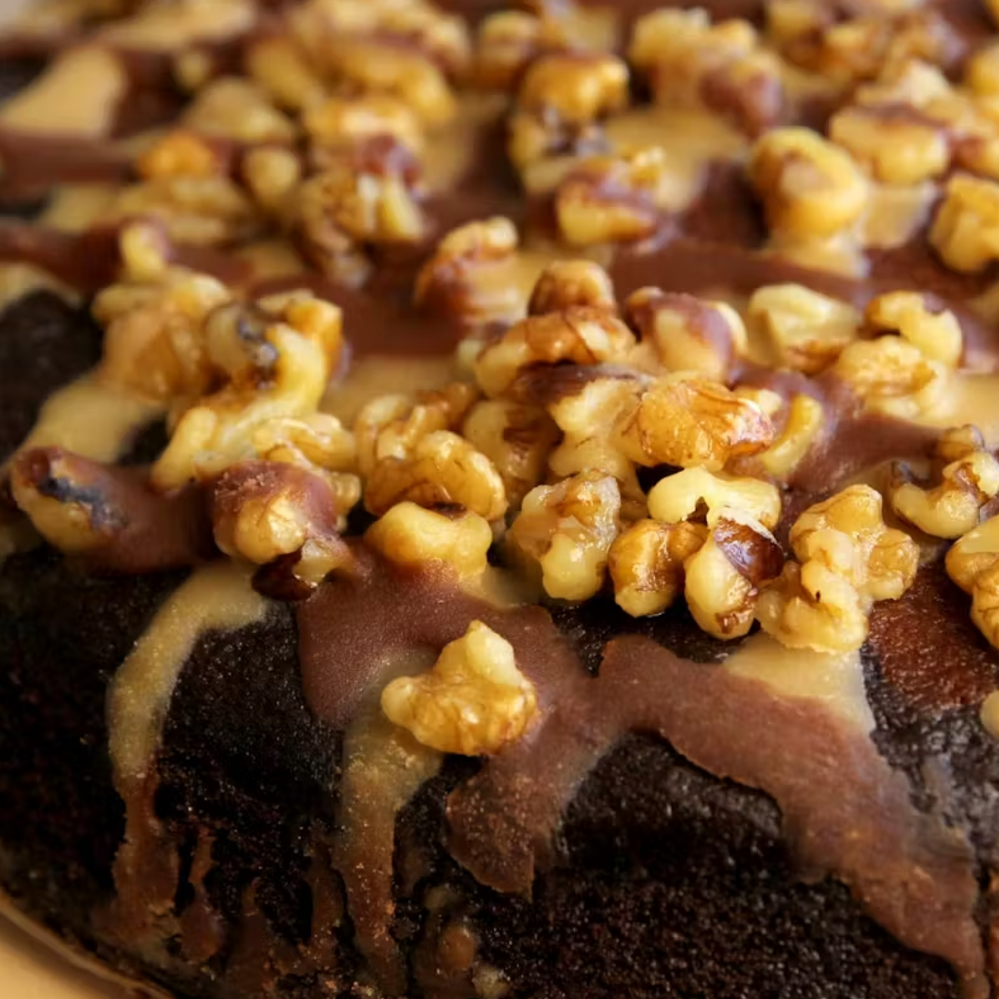 Close-up of a chocolate cake with caramel and walnuts