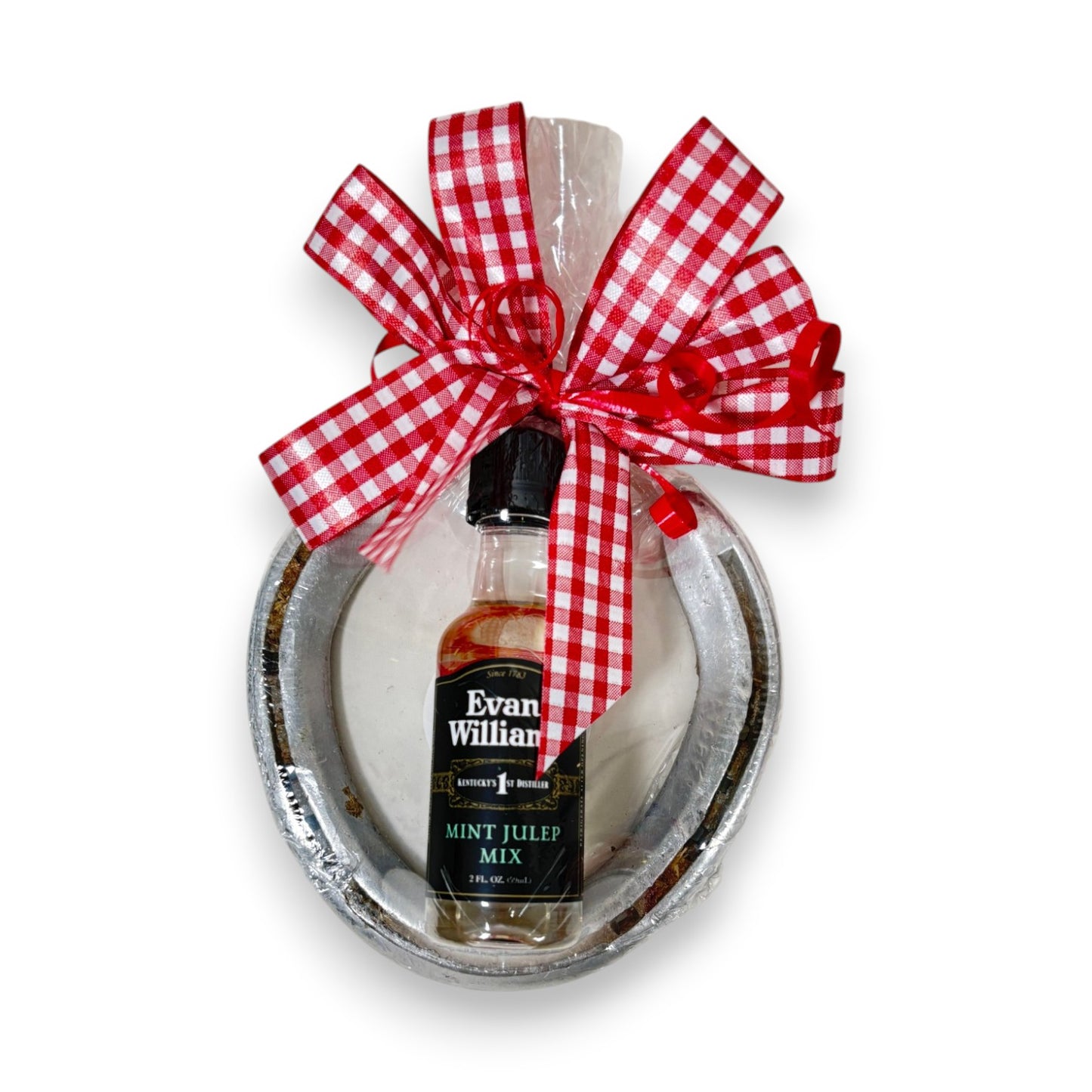 Authentic Churchill Downs horseshoe topped with a mini bottle of Evan Williams Mint Julep Mix, tied with a gingham bow on a white background.