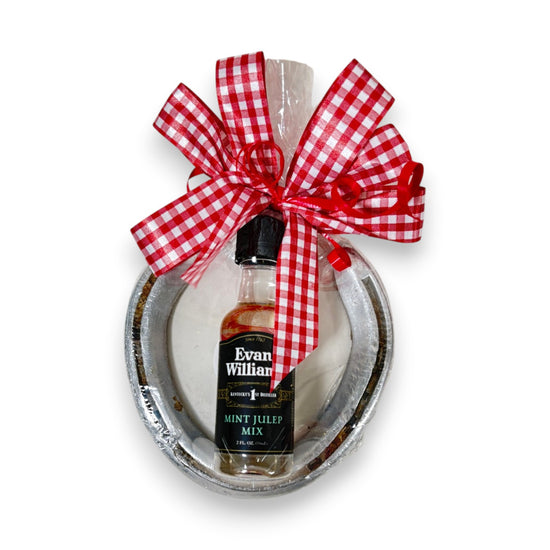 Authentic Churchill Downs horseshoe topped with a mini bottle of Evan Williams Mint Julep Mix, tied with a gingham bow on a white background.