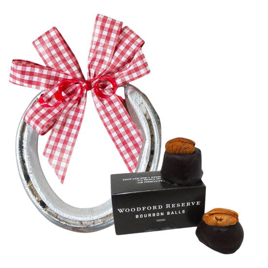 Kentucky Derby gift set showing a genuine track horseshoe with Woodford Reserve dark chocolate bourbon balls topped with pecans.