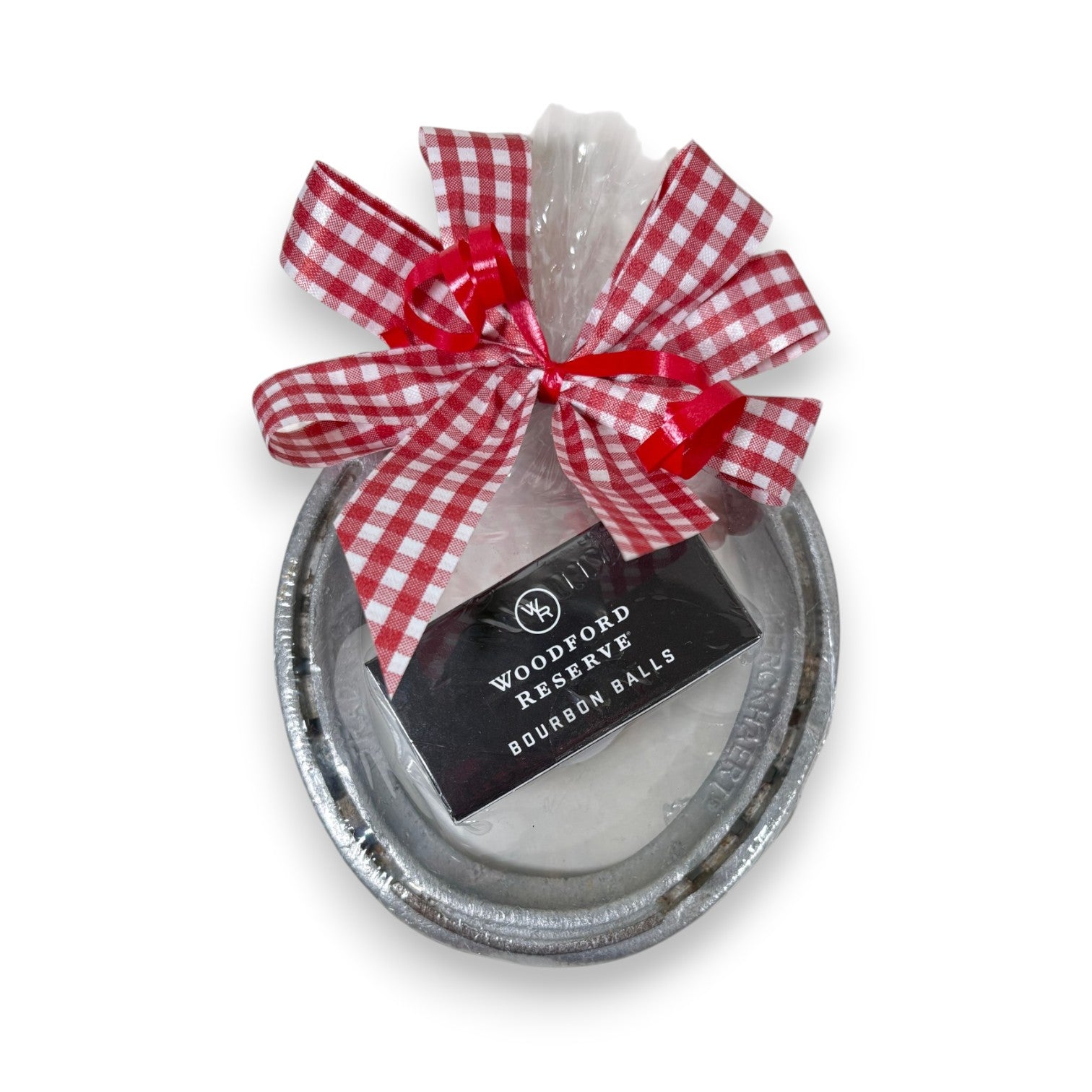 Authentic Churchill Downs horseshoe paired with a two-piece box of Woodford Reserve bourbon balls, tied with a gingham ribbon on a white background.