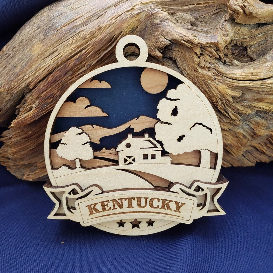 The Discover Kentucky State laser-cut wood ornament showing its three-layered scene against a white background.
