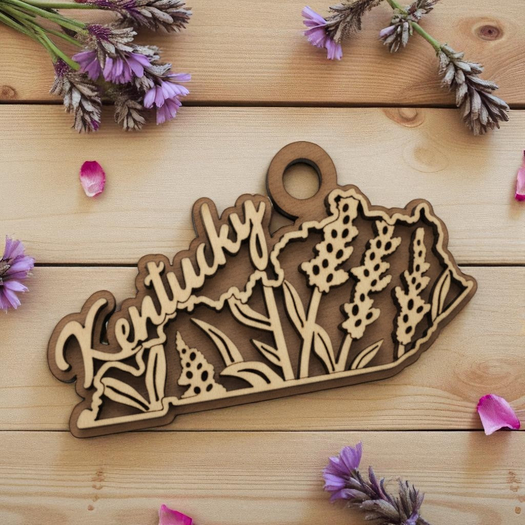 The Kentucky State Flower laser-cut wood ornament featuring the engraved flower on a maple and walnut base.