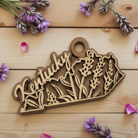 The Kentucky State Flower laser-cut wood ornament featuring the engraved flower on a maple and walnut base.