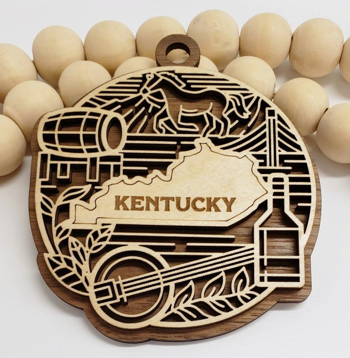 The Kentucky State Heritage laser-cut wood ornament showcasing iconic state symbols on a white background.