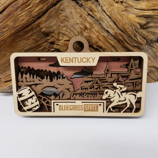 The Kentucky State License Plate laser-cut wood ornament with its maple, walnut, and cedar layers.