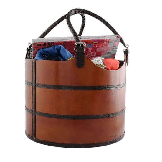 Brown leather tote bag with black handles and trim, filled with items on a white background