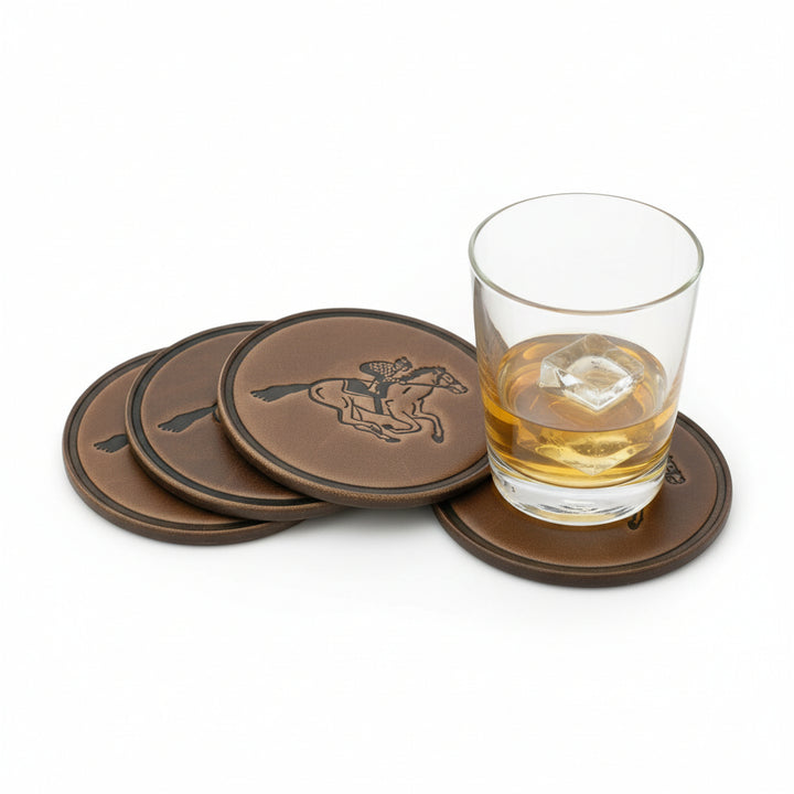 A glass of bourbon resting on a Thoroughbred leather coaster, highlighting the rich texture and racehorse graphic.