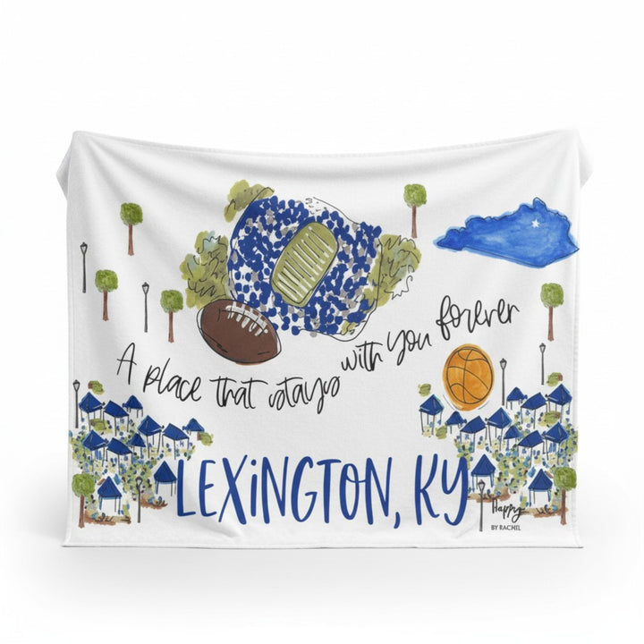  Flat lay of the Lexington Saturdays Game Day Fleece Blanket displaying stadium, Kentucky silhouette, and heartfelt phrase in blue and green hues.