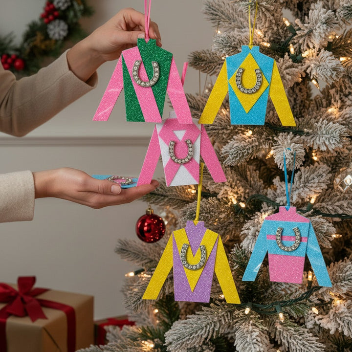 A group shot of all five handcrafted jockey silk ornaments hanging on a Christmas tree.