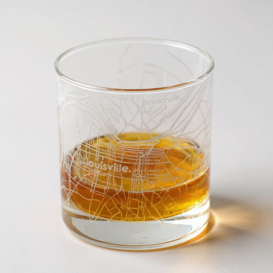 A close-up detail of the intricate street map etched onto the whiskey glass.