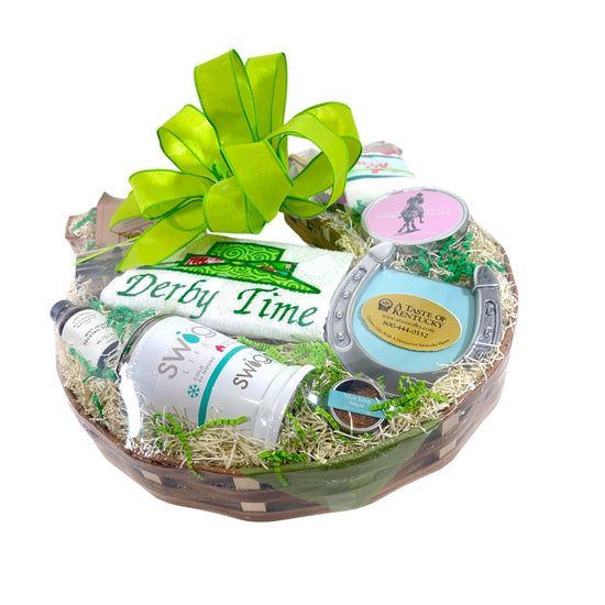 A beautiful horseshoe-shaped gift basket filled with Kentucky Derby items, finished with a signature green bow.