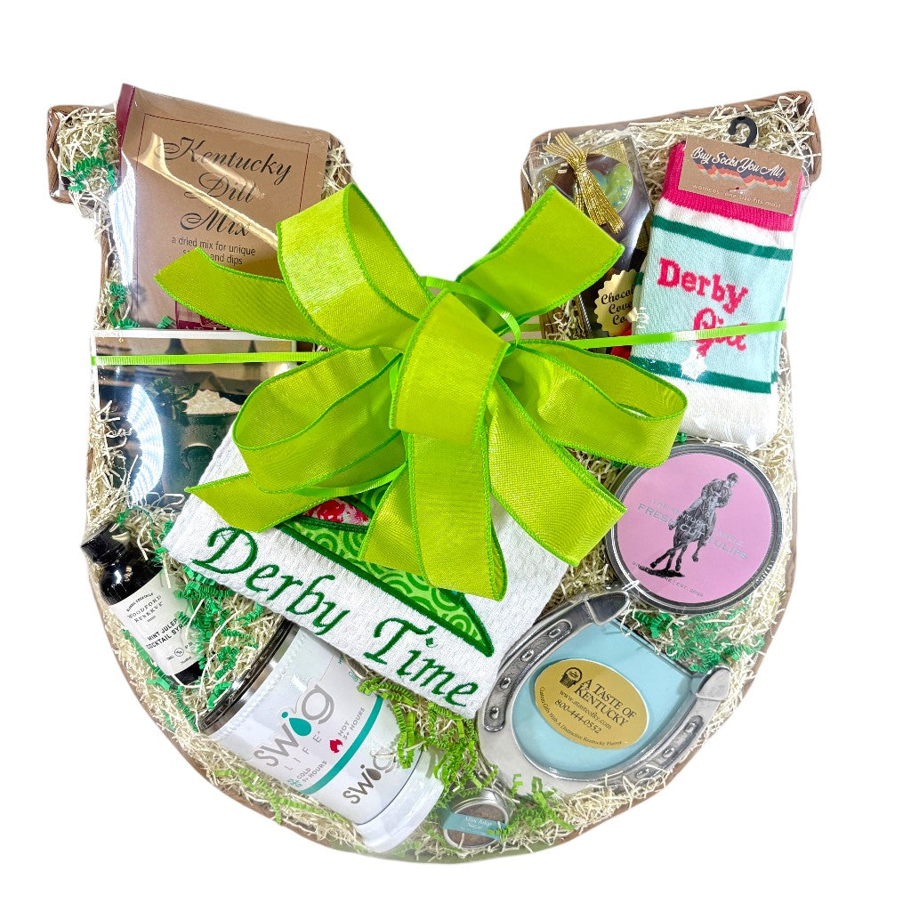 A beautiful horseshoe-shaped gift basket filled with Kentucky Derby items, finished with a signature green bow.