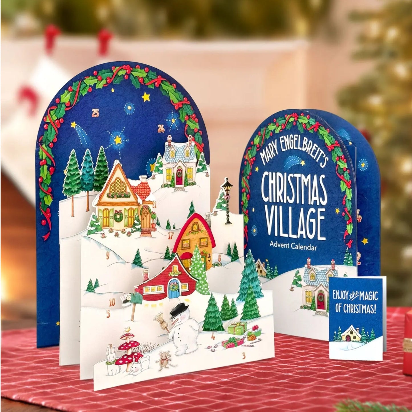 Christmas village advent calendar with festive design on a table.