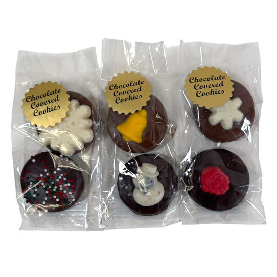 Packaged chocolate-covered cookies with decorative toppings on a white background