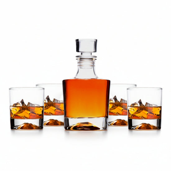 The complete whiskey decanter and four-glass set, showcasing the unique mountain design in the base of each piece.