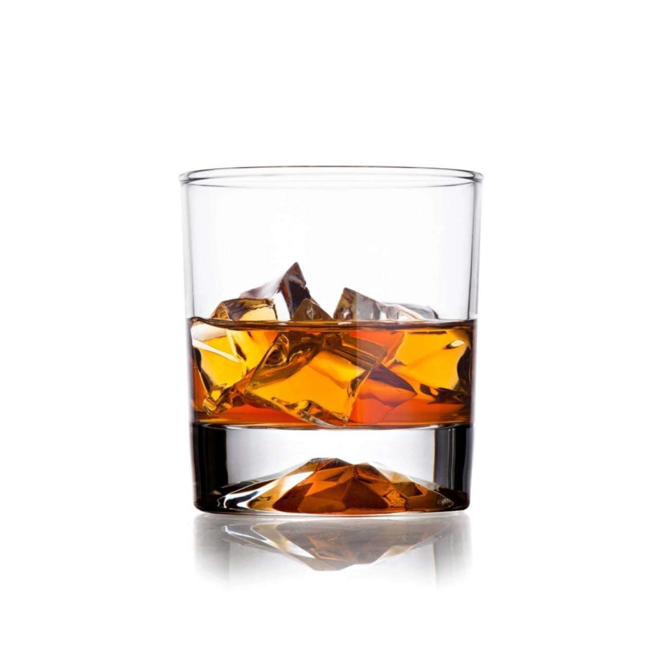 Glass of whiskey with ice cubes showcasing the unique mountain design in the base on a white background