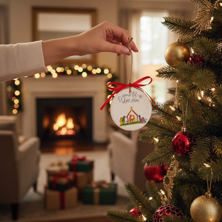A festive Christmas tree scene featuring the 'O come let us adore Him' Nativity ornament.