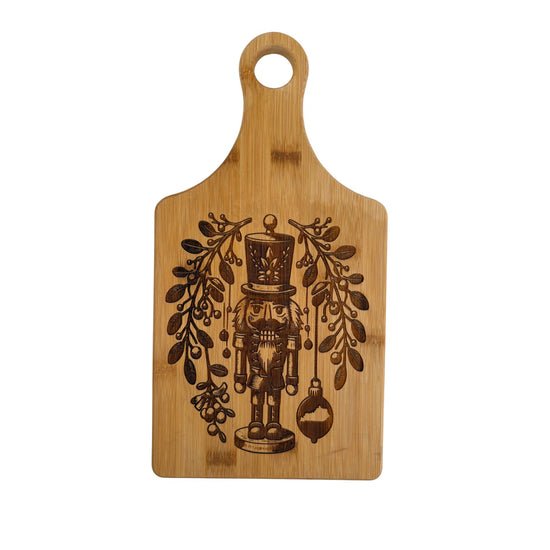 Wooden cutting board with a nutcracker design on a white background