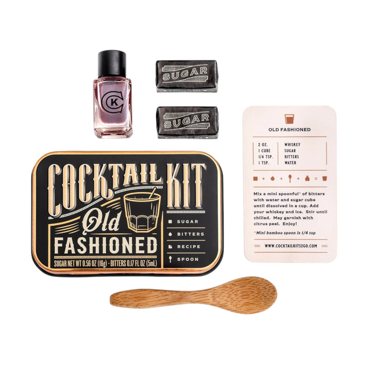 A flatlay of the Old Fashioned kit contents: bitters, sugar, recipe card, and mini spoon.